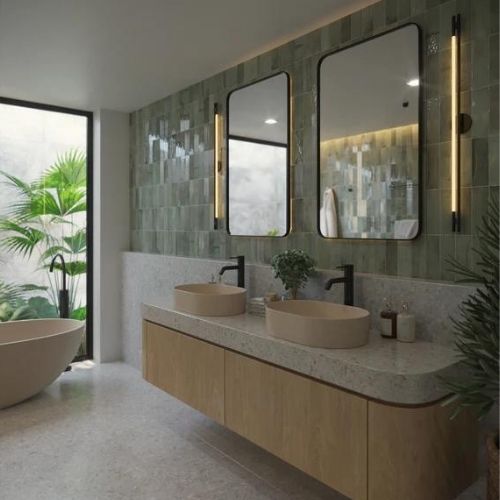 Bathroom renovation with green tiled walls and freestanding bath