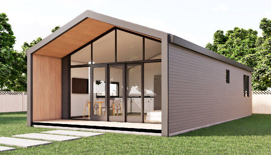Modern granny flat exterior with grey cladding, a timber feature wall and glass sliding doors