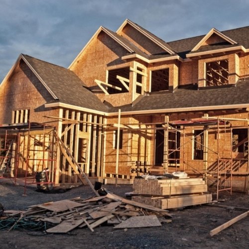 New two-storey home frame under scaffolding as part of a knockdown-rebuild project