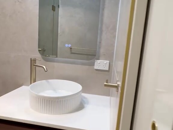 Finished bathroom with gold framed shower screen