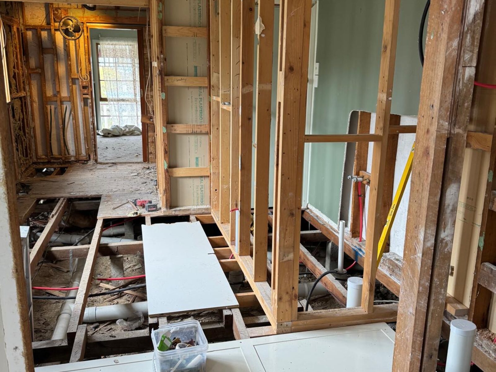 Floor strip-out exposing joists for re-levelling